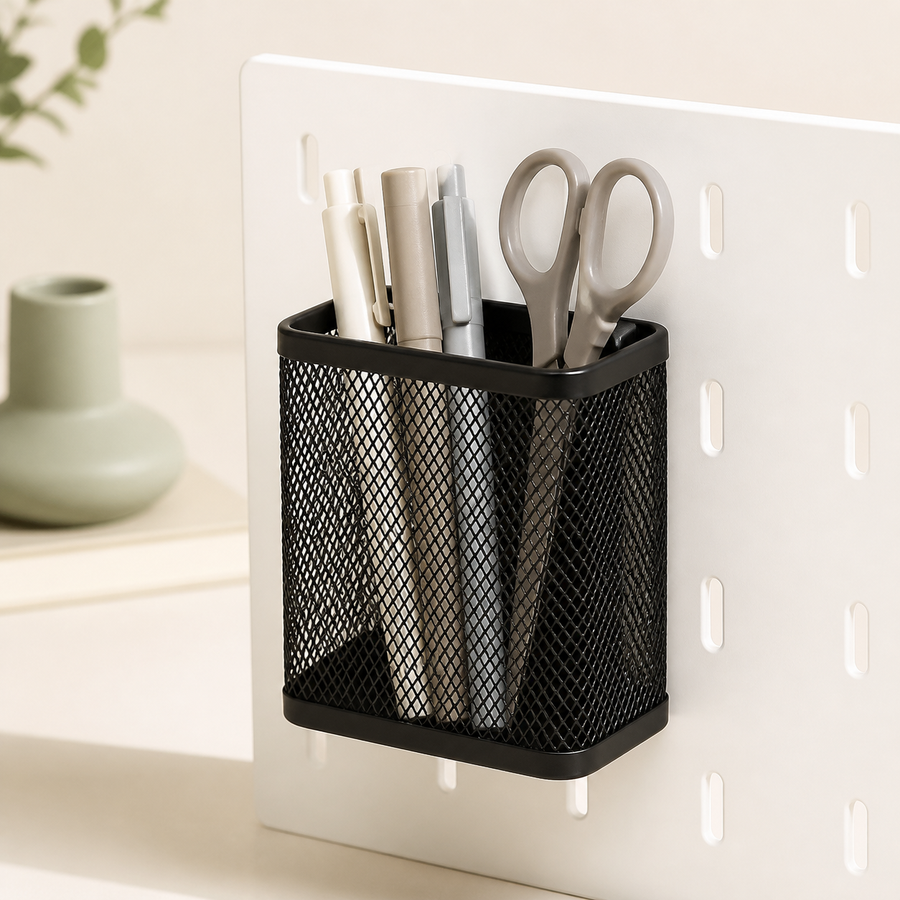 Black Cumya magnetic mesh organizer holding pens and scissors on a white metal board