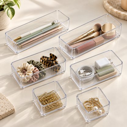 Six clear Yoaxo drawer trays in three sizes with small essentials
